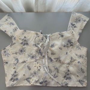 beige and blue floral crop top with zipper on the back